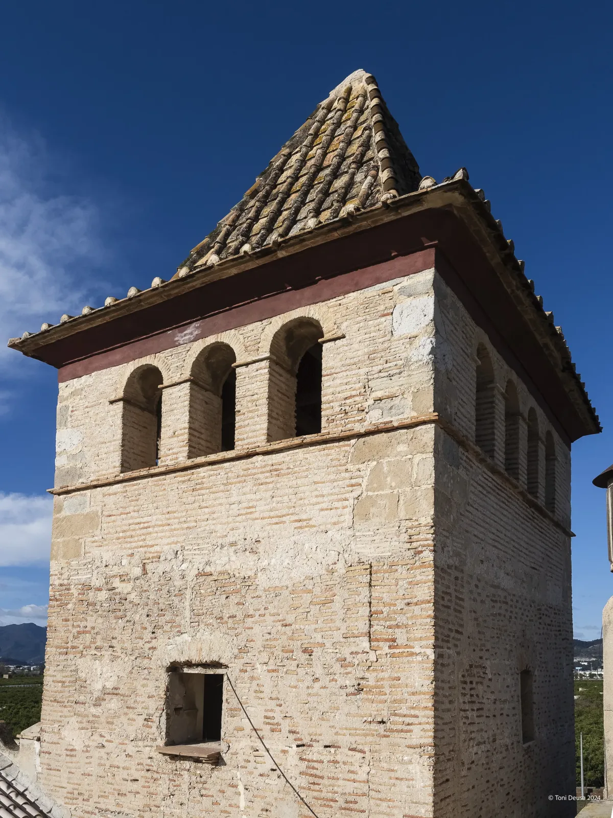Esquina superior del torreón de la Torre dels Pares, con sillares en el ángulo y ventanas de arco de medio punto